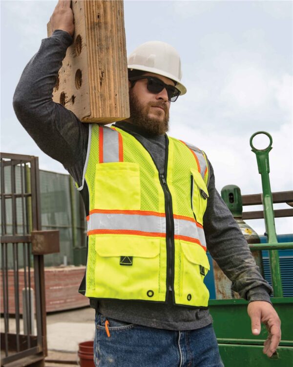 Construction worker wearing lime ML Kishigo Premium Black Series Heavy Duty Vest 1513-1514